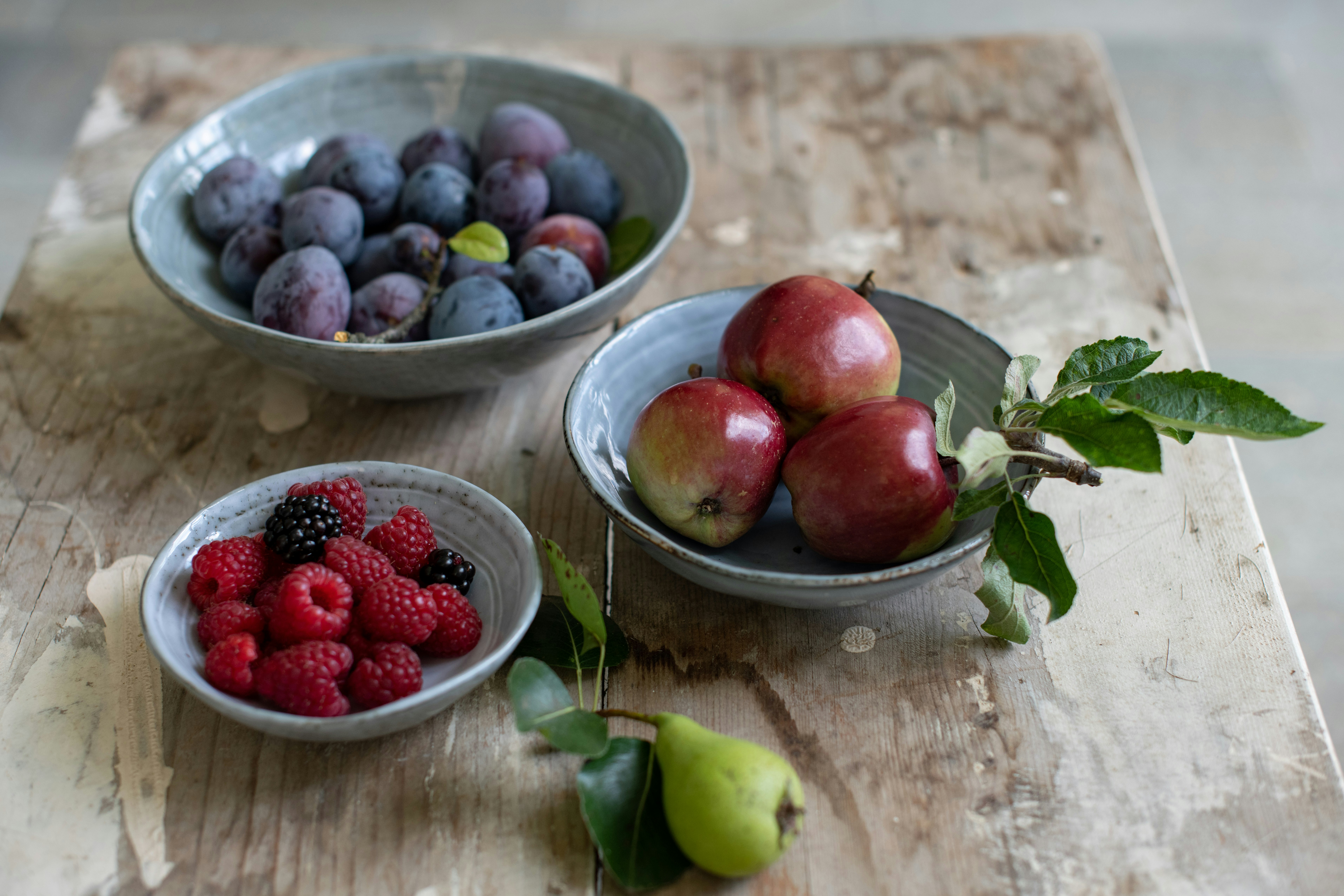 red and green apples on white ceramic bowl